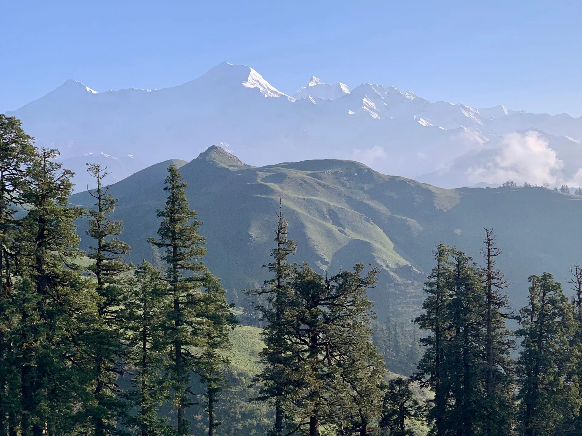 Aerial view of Dayara Bugyal’s rolling meadows with distant Himalayan peaks